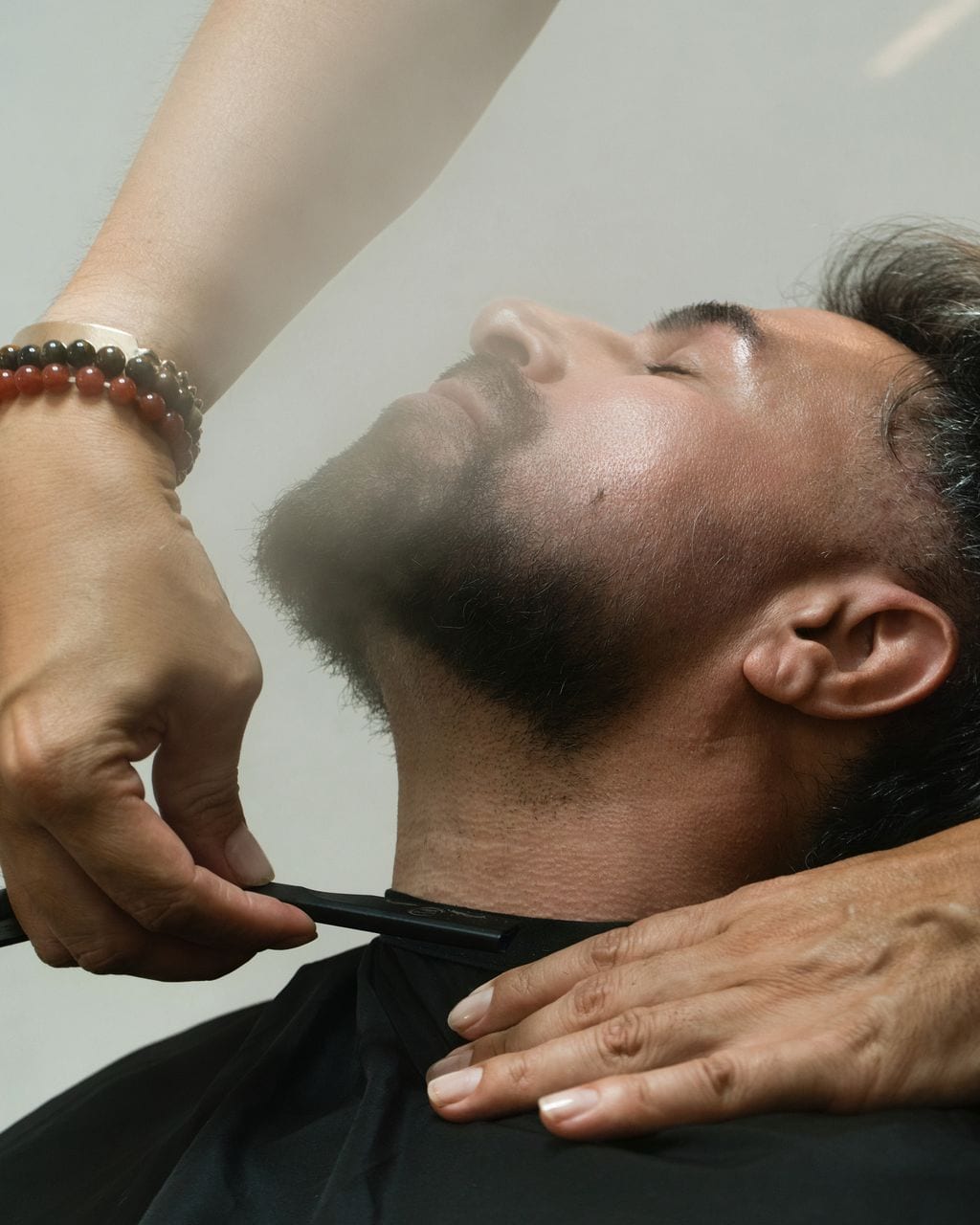 Reclined client during neck detailing
